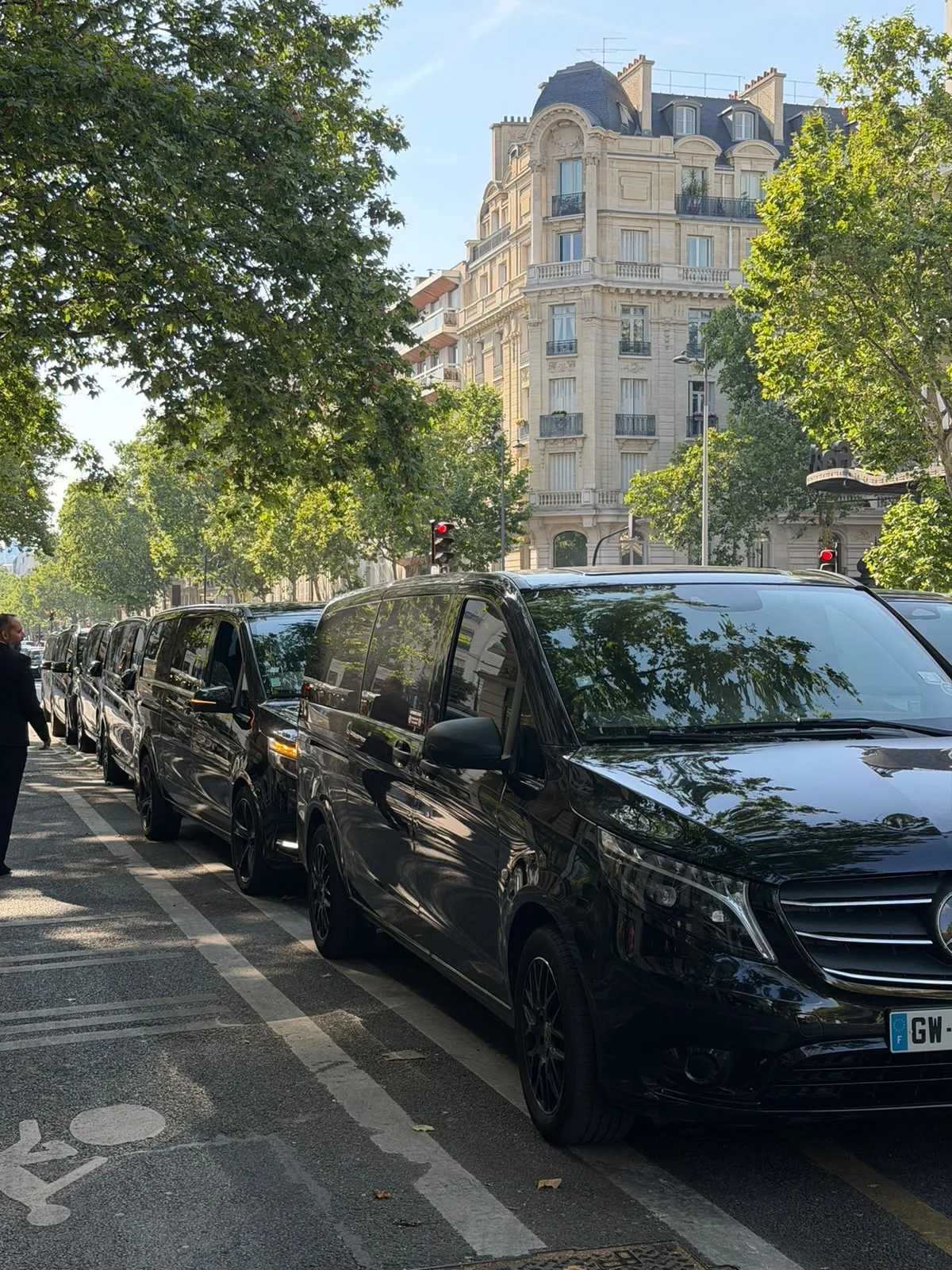 Line of black Mercedes V-Class chauffeur vehicles in Paris